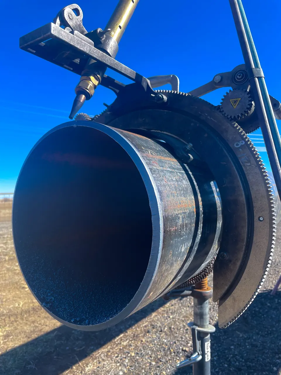 Pipe beveling machine on a large steel pipe at a jobsite